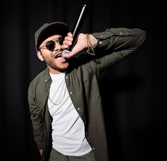 Hip-hop vocalist performing into a microphone